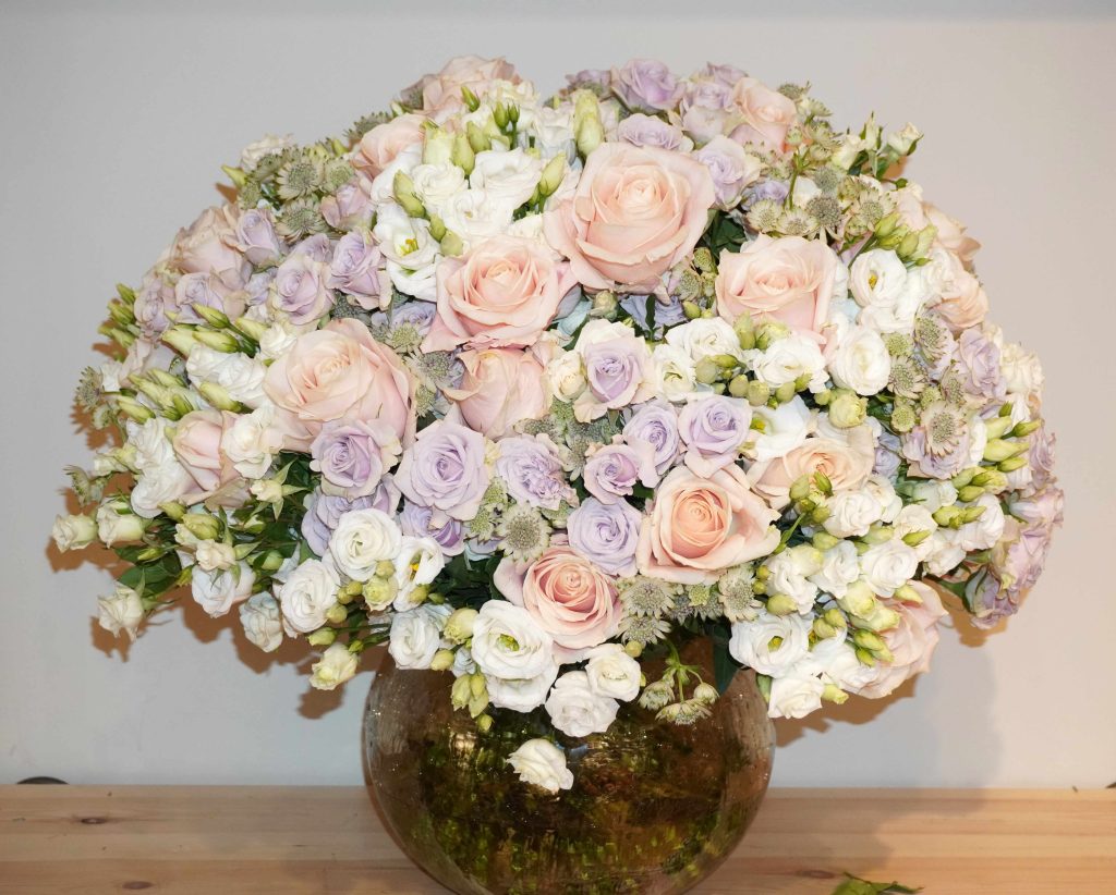 Luxury hand-tied bouquet featuring roses, spray roses, lisianthus, and garden roses in soft pastel tones – The Rochet Bouquet by Bernard Rochet London.