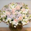Luxury hand-tied bouquet featuring roses, spray roses, lisianthus, and garden roses in soft pastel tones – The Rochet Bouquet by Bernard Rochet London.
