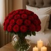 50 red roses in dome shape arranged in a fishbowl vase with candles beside the bed – Bernard Rochet London
