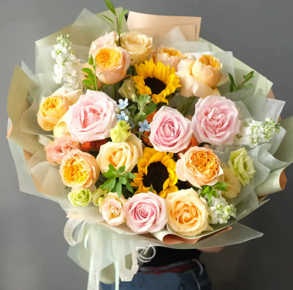 Yellow and pink bouquet with sunflowers, garden roses, spray roses and seasonal fillers – bright and cheerful summer floral arrangement.